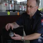 Fire safety officer Barry Gibson holds a gas regulator that caused a small fire in Dunedin. Photo...