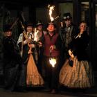 Fire-stick juggler James East welcomes steampunk ball-goers (from left) Fiona Rutland, from...