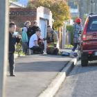 Firefighter Kerry McNamara talks to a woman from a house fire in Beresford St. Photo by Craig Baxter