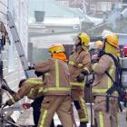 Firefighters at the scene of a house fire at Richmond St, Forbury, on Sunday evening.  Photo by...