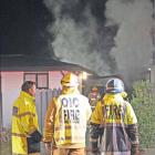 Firefighters attend a blaze in a garage/sleep-out in Alexandra yesterday. Photo: John Douglas
