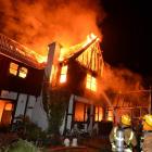 Firefighters battle a house fire in St Leonards Dr, Dunedin, about 3am yesterday. The window from...