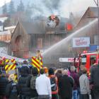 Firefighters battle the blaze in the building that houses the World Bar, Fat Badgers Pizza and...