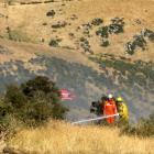 Firefighters dampen hotspots after a fire near Ettrick. Photo by Paul Mooney.