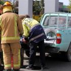 Firefighters examine the ute damaged by fire at the Invercargill Pak'n  Save fuel facility...