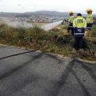 Firefighters extinguish a grass fire believed started by sparks caused by a car doing a burnout...
