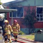 Firefighters outside the house in Kelso Pl, south Invercargill, extensively damaged by fire...