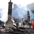 Firefighters  work to control the blaze at the Paradise homestead. Photo by the ODT.