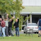 Fisher and Paykel workers wave to the camera while attending a farewell barbecue at the company's...