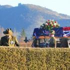 Flanked by army personnel, a gun carriage bearing the casket of Eric Batchelor arrives at Waimate...