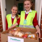 Beth Lynch (left) and Rosa Miller, of Balmacewen Intermediate School, help  at FoodShare to see...