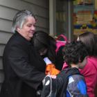 Forbury School principal Janice Tofia hugs Anastasia Ashley (12), while Nicolai Ashley (7) and...