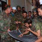 Forces loyal to President Bashar al-Assad look at a map at Suleiman al-Halabi neighbourhood in...