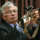 Forensic Scientist Peter Hentschel giving evidence, handling the murder weapon, at David Bain's...