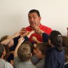 Former All Black Kees Meeuws is surrounded by pupils during a visit to  St Mary's School in...