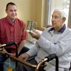 Former All Whites striker Steve Wooddin presents Otago football stalwart Les Watson with a...