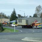 Former Balclutha Primary classrooms pass the Rosebank Lodge in Balclutha yesterday on their way...