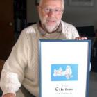 Former Dunedin librarian Allan Barnes with the award he received for his work as a cataloguer.