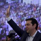 Former Greek Prime Minister Alexis Tsipras waves during a meeting with members of his Syriza...