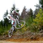Former junior world downhill mountain bike champion Scarlett Hagen gets air at the Queenstown...