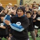 Former Otago halfback Stu Forster leads a group of primary school rugby players in the haka at a...