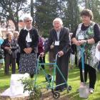 Former pupils  are welcomed by Willie Campbell (right), who grew a commemorative oak tree from an...