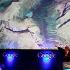 Former Vice President Al Gore points at a screen showing the new Google Earth 5.0 at the...