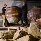 Fortune Theatre set designers Matt Best (left) and Peter King load pots into the Standard...