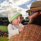 Four-month-old Riley Culling and father Jared enjoy the cricket test at the University Oval, in...