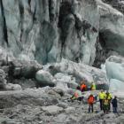 Fox Glacier guides and police escort family members of the two dead tourists from the area of...