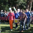 Frana Cardno's coffin is carried into the service by family members (clockwise from left) son...