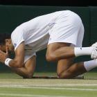 France's Jo-Wilfried Tsonga reacts after defeating Switzerland's Roger Federer in their...