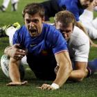 France winger Vincent Clerc celebrates scoring his team's first try in the tackle of England...