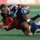 Francis Saili of the Blues fends off Daniel Carter of the Crusaders.