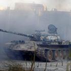 Free Syrian Army fighters drive a tank towards the front line in Aleppo's Sheikh Saeed...