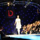 Front-row audience members  watch a model  on the catwalk at the iD Dunedin Fashion Show on...