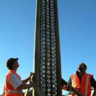 Fulton Hogan Central staff Michael Zimmer-mann (left) and Simon Dickson admire Clyde artist Tracy...