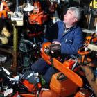 G&J Swann Saw and Mower small motor mechanic John Ferguson sits among a growing pile of returned...