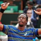 Gael Monfils of France celebrates defeating Ernests Gulbis of Latvia in their men's singles match...