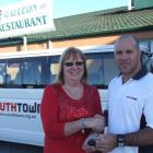 Galleon co-owner Marjie Familton presents the keys of a van to new Youthtown co-ordinator Mike...