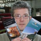 South Otago Museum curator Gary Ross shows off two heritage-related brochures launched this week....