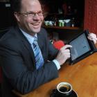 Gen-i client manager Matt Baker demonstrates the versatility of the iPad. Photo by Peter McIntosh.