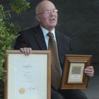 George Street Normal School principal Rod Galloway shows off the Woolf Fisher Fellowship awards...