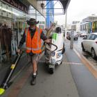 Giant vacuum . . . Fulton Hogan street-cleaner Daryl Williams tries out his new toy, the Glutton....