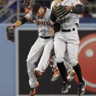 Giants left fielder Gregor Blanco (left) and right fielder Hunter Pence celebrate beating the...