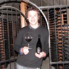 Gibbston Valley Wines winemaker Christopher Keys shows a bottle of 2008 Reserve Pinot Noir, which...