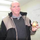 Glass Earth Gold chief executive officer Simon Henderson holds  3.4 ounces of gold recovered from...