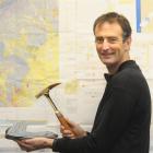 GNS Science geologist Dr Simon Cox holds the gold-plated McKay Hammer, a leading national...