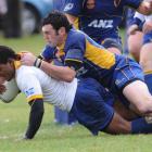 Gold second five-eighth Lex Kaleca scores under the tackle of Blake Korteweg in the Otago trial...