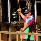 Demolition man . . . Arrowtown Rugby Club coach Richie Anderson dismantles part of the Mt Soho...